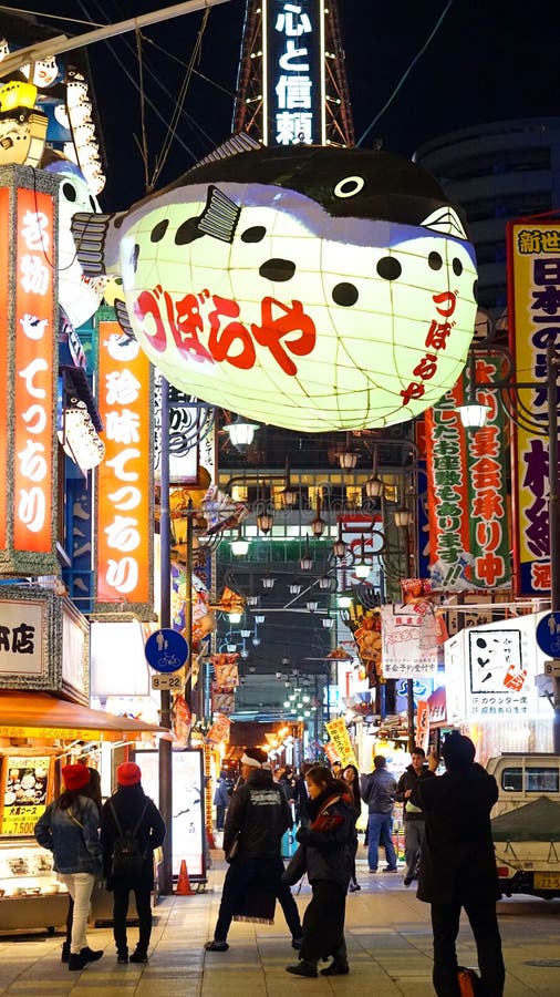 Osaka, Japan - March 2015: shinsekai, tsutenkaku restaurant street area with landmark fish latern neon signs. Osaka, Japan - March 2015: shinsekai, tsutenkaku royalty free stock photography